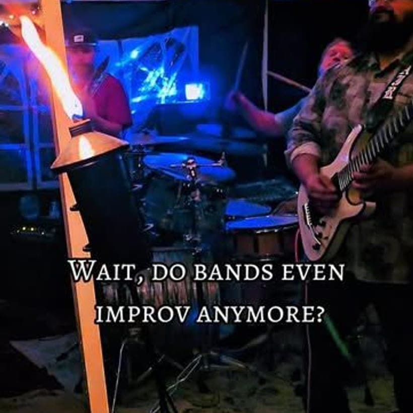 Orbitals guitarist bathed in blue stage light